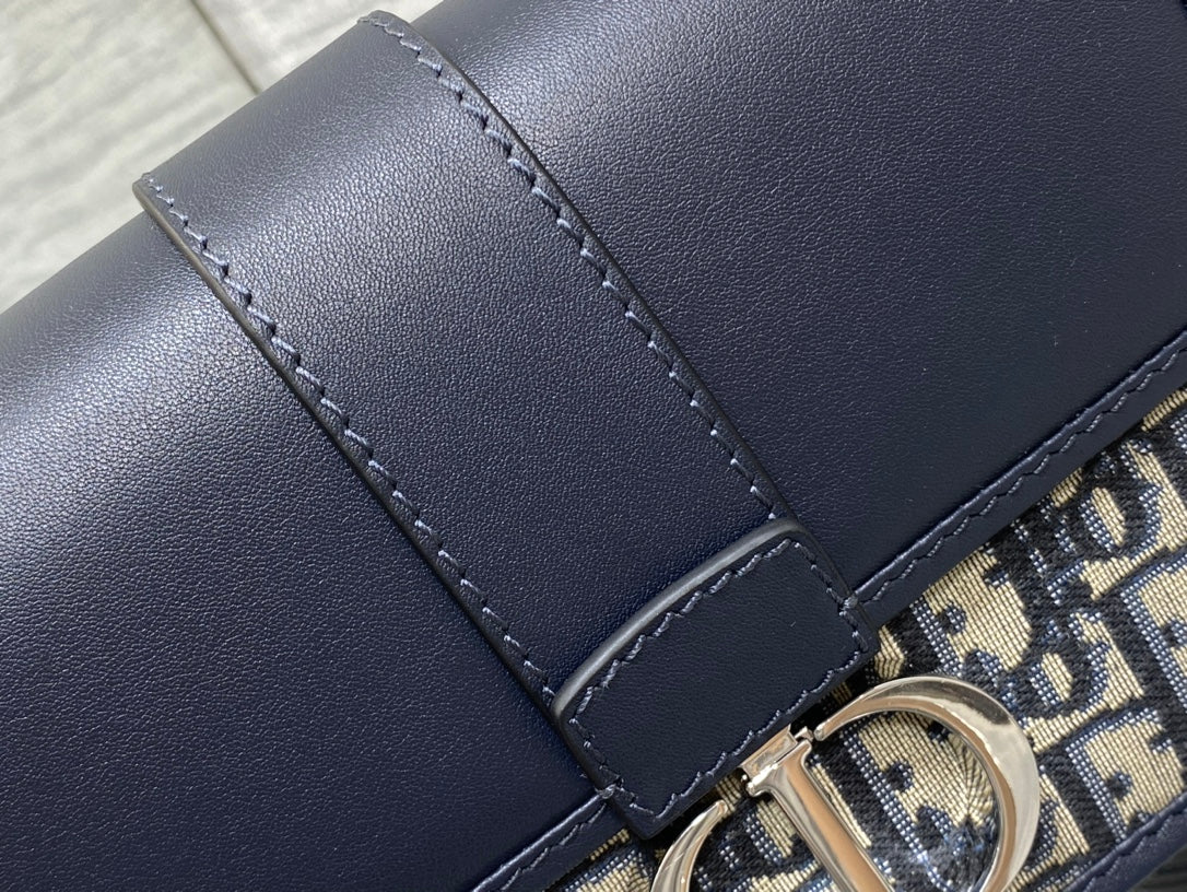 MONTAIGNE EAST-WEST 21 BAG WITH CHAIN IN NAVY BLUE LAMBSKIN AND MONOGRAM JACQUARD